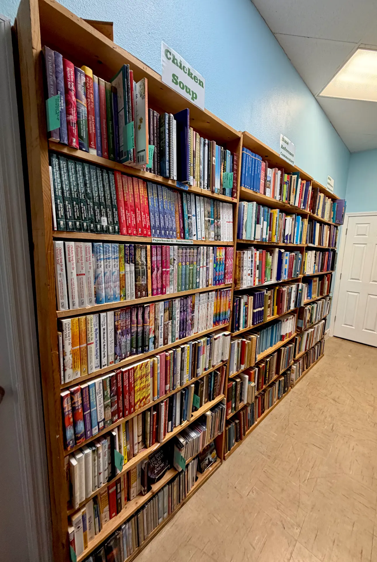 Shelves holding Chicken Soup for the Soul and Bible reference titles