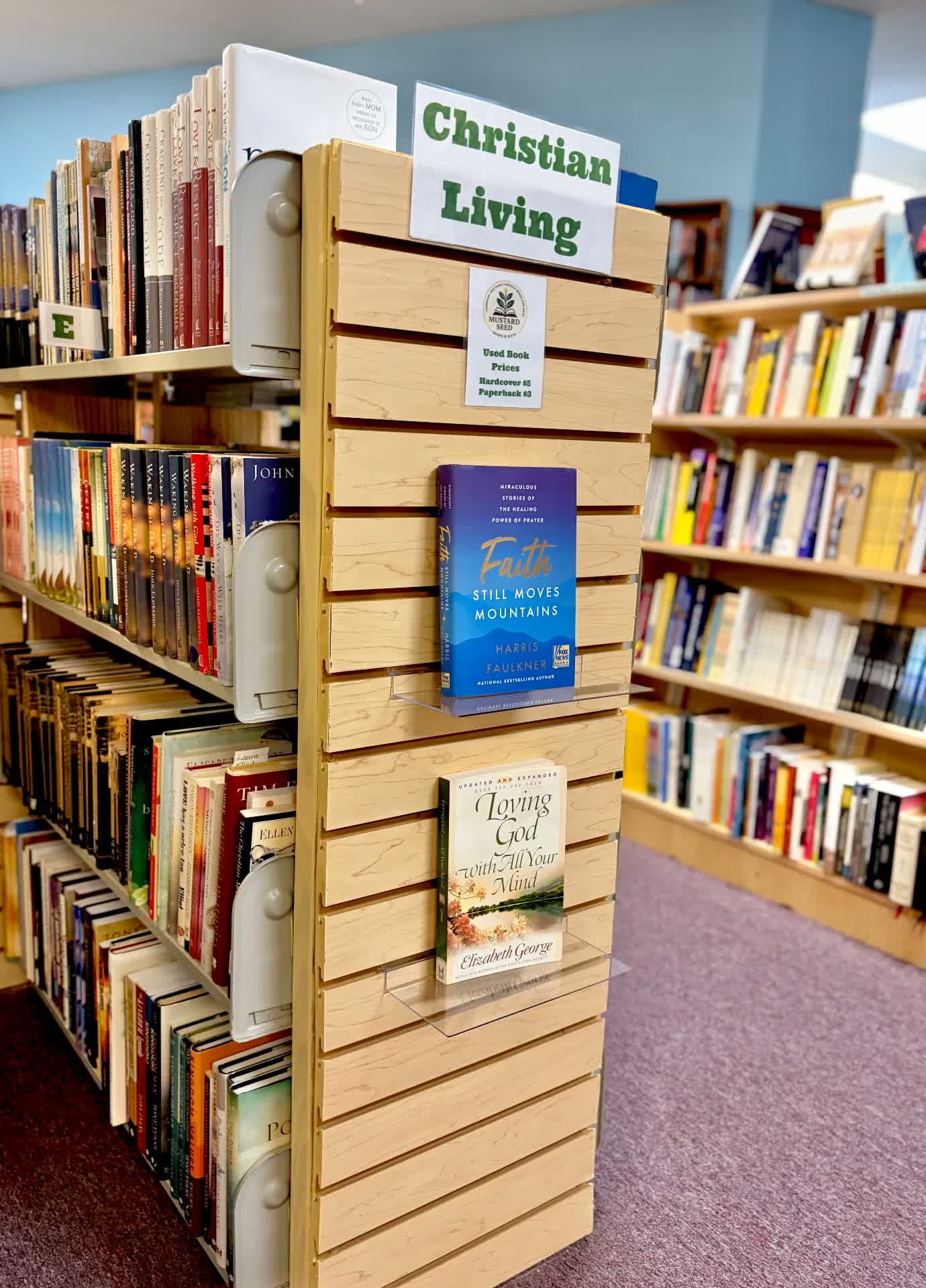 Christian Living endcap display with featured titles and used book prices sign