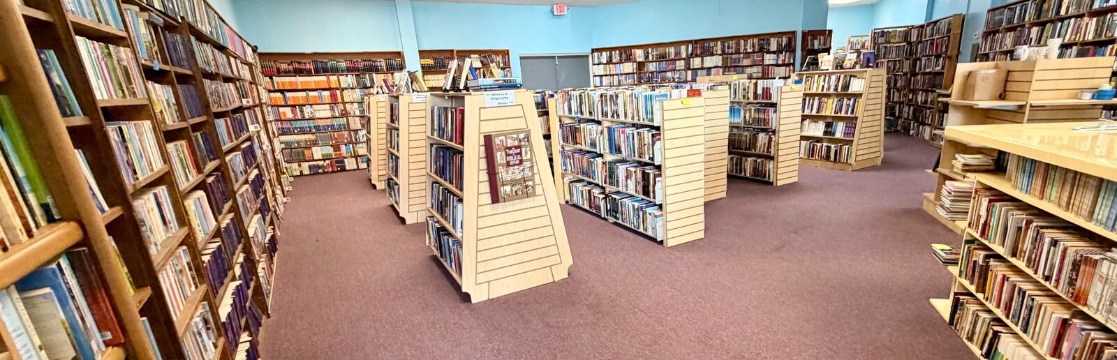 Wide view of the bookshop interior with rows of used books