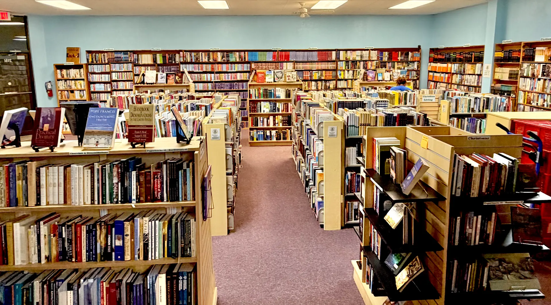 Wide view down the aisles of the shop with Christian Living signage