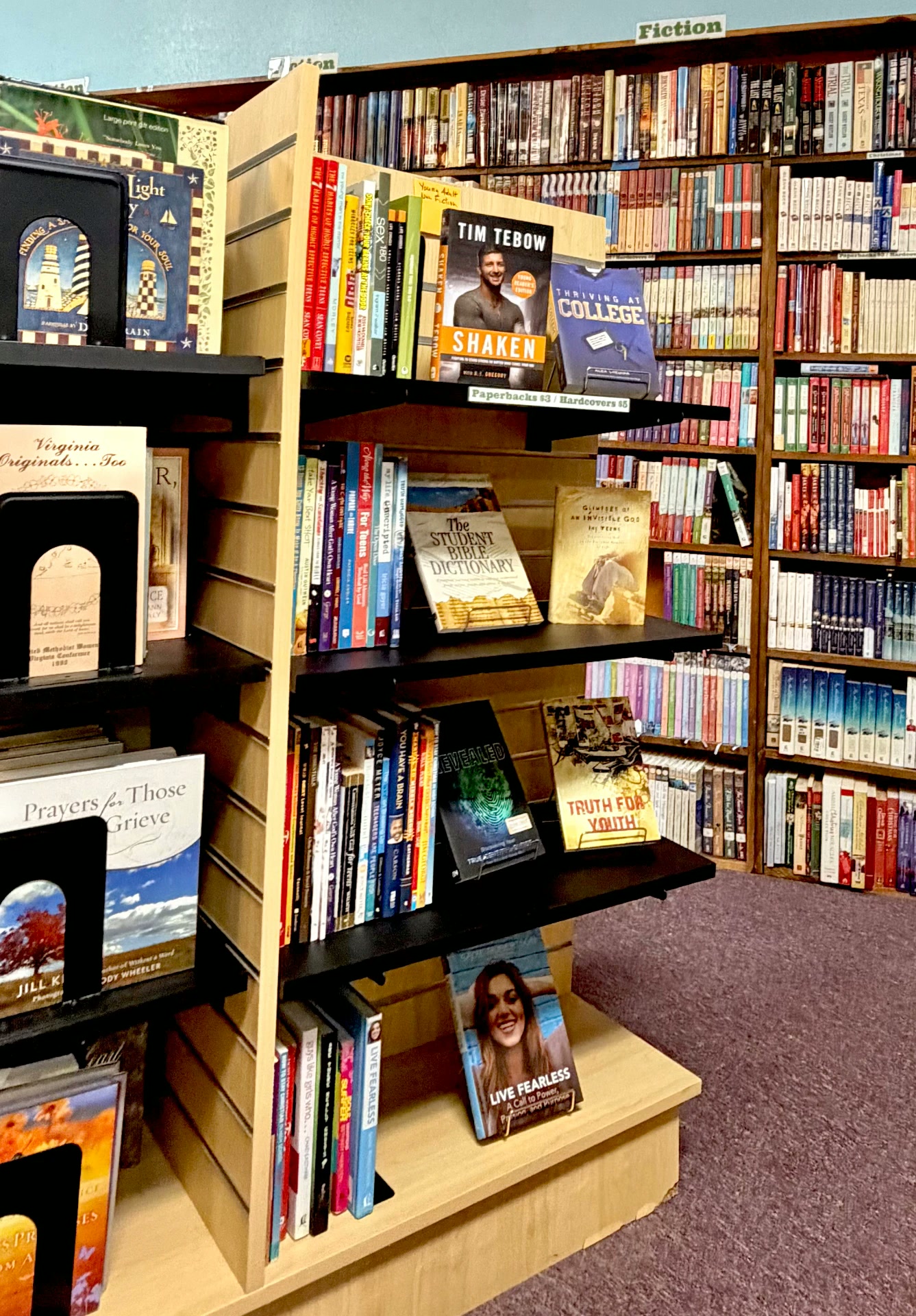Shelves of fiction, devotionals, and youth titles