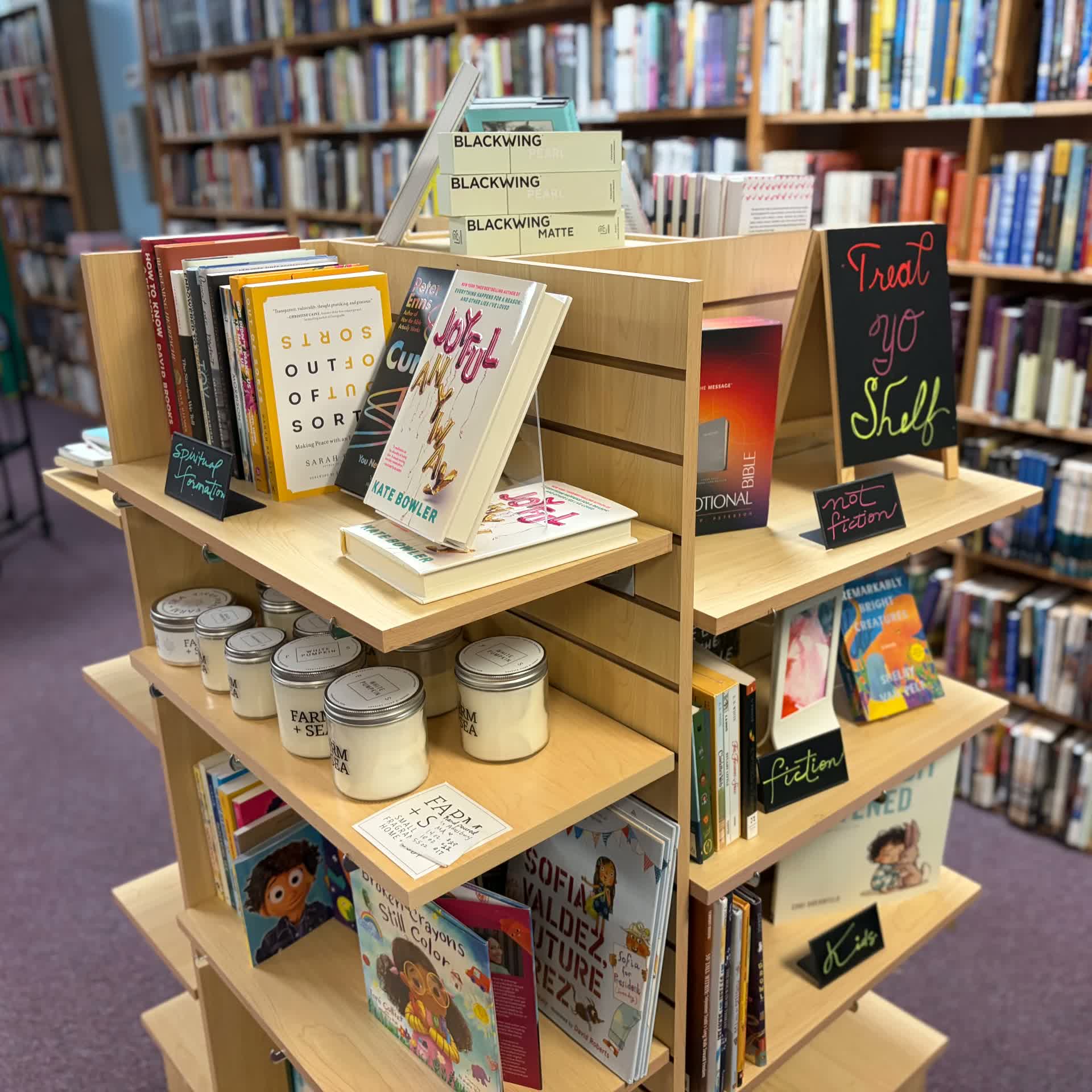 New books, candles, and gift items on a display fixture